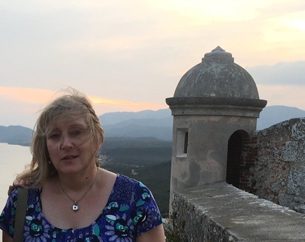 me becoming a wise woman standing in front of a castle with a view of the ocean.