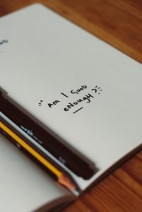 An open notebook with a pencil on it, serving as a platform for women looking to empower themselves and overcome low self-esteem or lacking confidence.